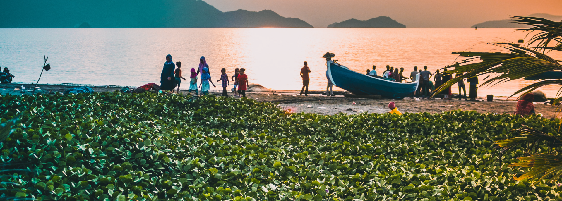 busy people by the small fishing boat in the shore